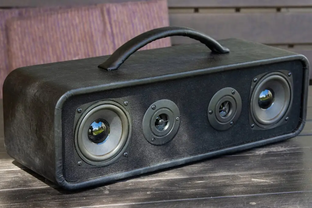 Bluetooth speaker on a table at a backyard barbecue