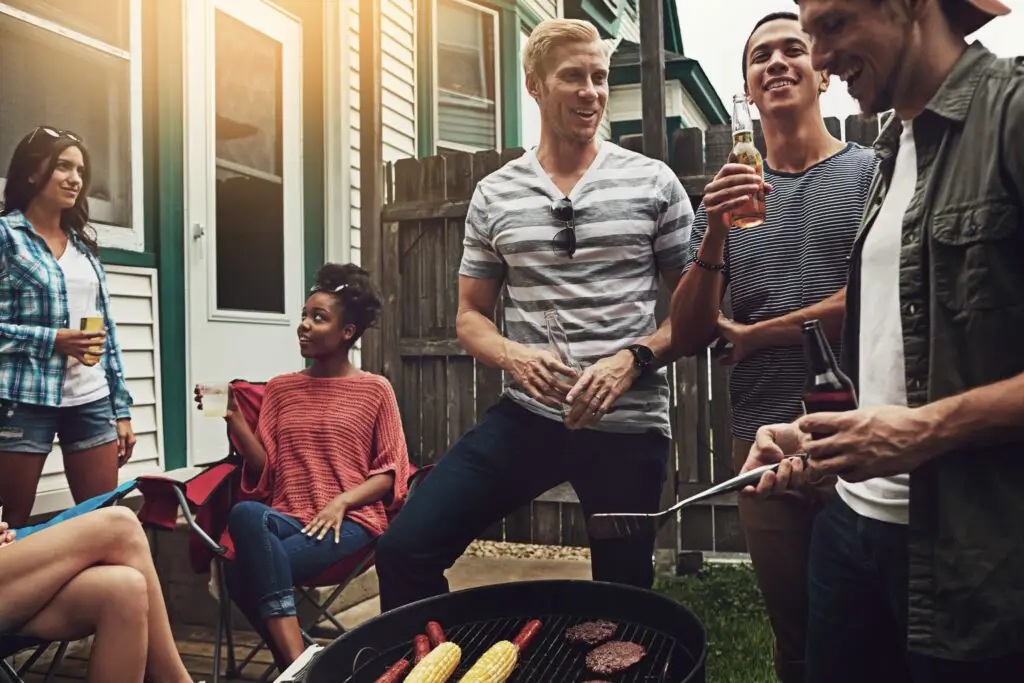 A group of friends gathered on a deck for a barbecue