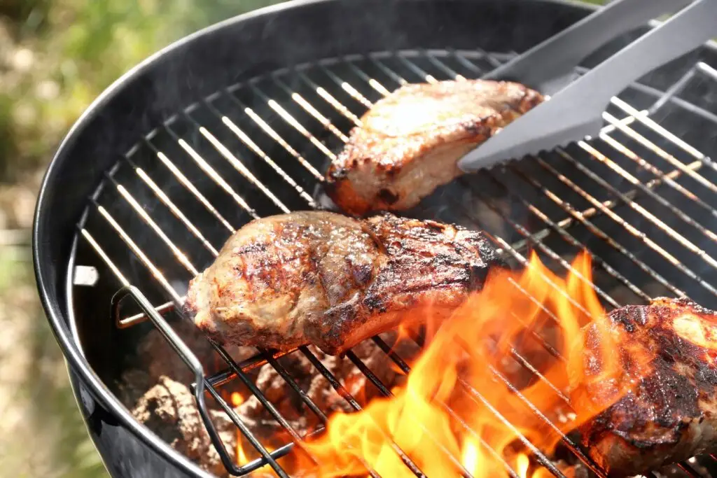 Barbecue pork chops on a charcoal kettle grill