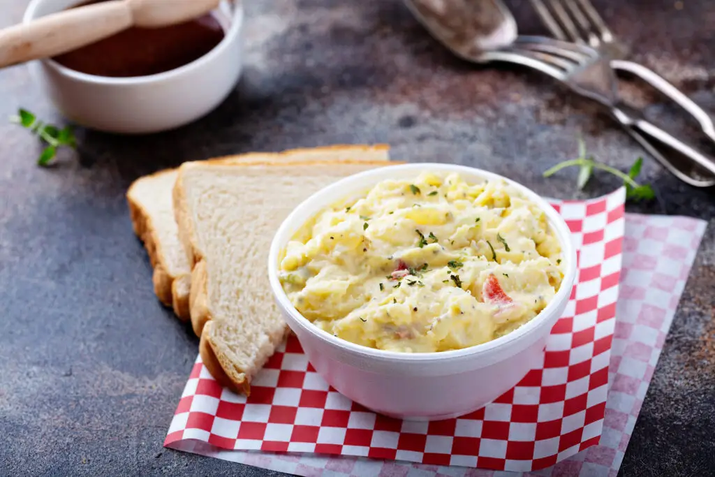 Potato salad in a white bowl on a table