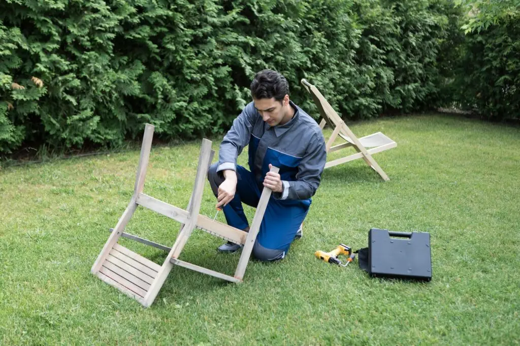 Man fixing outdoor furniture in the backyard